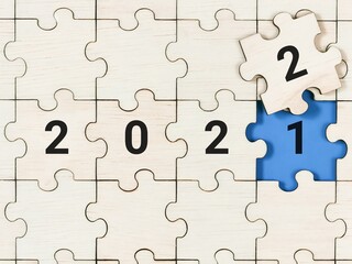 Top view of replacing puzzle pieces with 2021 to 2022. New year concept.
