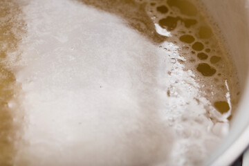 Close-up of a drop of vegetable oil on the surface of a broth or vegan soup