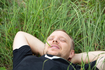 Caucasian hipster  lying on grass, relax, happyness