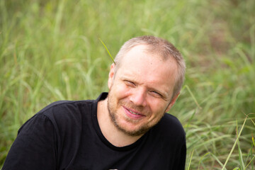 Caucasian hipster  sitting on grass, relax, happyness