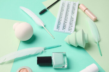 Makeup supplies on color background