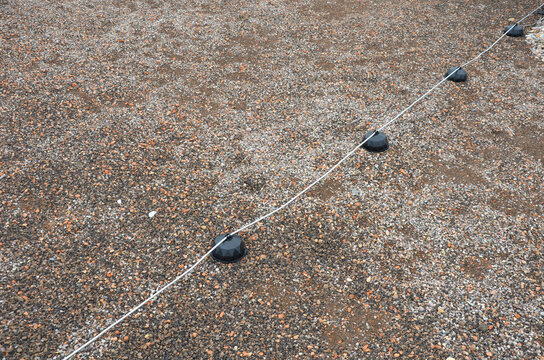 A lightning conductor is used to protect buildings from lightning that can damage a house or its electrical equipment is routed to the highest points of a green garden roof.