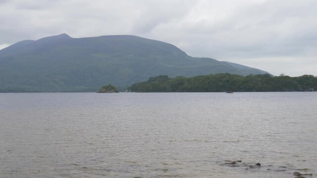 Deep Lake Of Muckross Alongside Rugged Coves With Mountain View In Killarney National Park, County Kerry, Ireland. wide shot