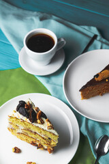 Pistachio cake, sponge cake with nuts decoration on a white plate.