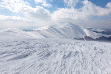 Winter Carpathian mountains. Borzhava mountain range. landscapes of winter mountains. Snow drifts are treated by the wind, against the background of winter mountains.