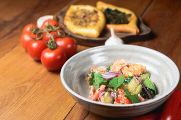 Salad with beef, onion and cilantro in sweet and sour sauce. Served in a bowl over rustic wooden background.