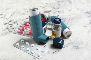 Inhalers and medicines on grunge background