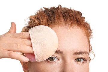 Beautiful young woman with makeup sponge on white background, closeup