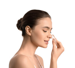 Beautiful young woman with makeup sponge on white background