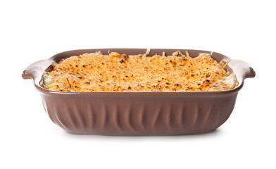 Baking dish with tasty green lasagna on white background