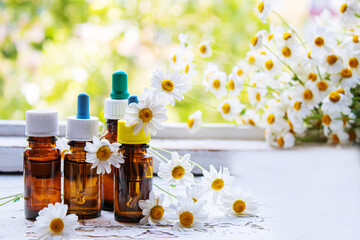 Medicinal herbs in bottles. chamomile oil extract. Selective focus.