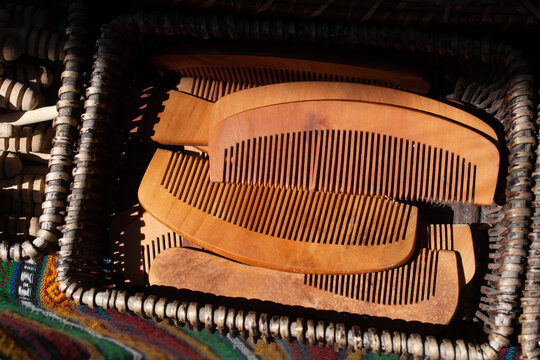 Pile of wooden combs in a box