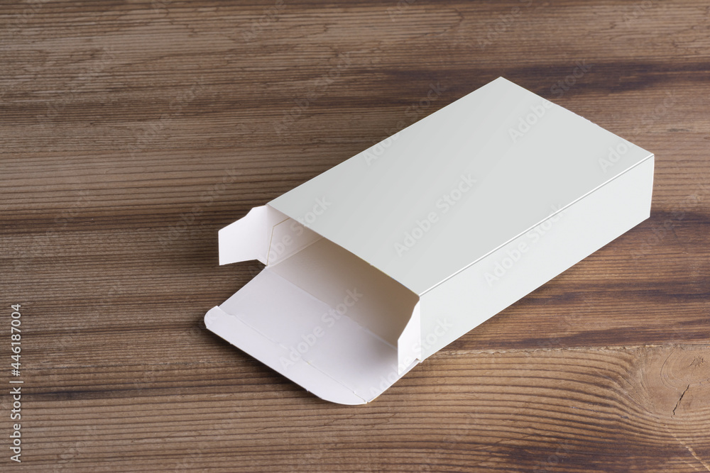 Poster opened empty pillbox on wooden table background, mock-up series template ready for your design