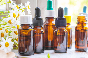Medicinal herbs in bottles. chamomile oil extract. Selective focus.