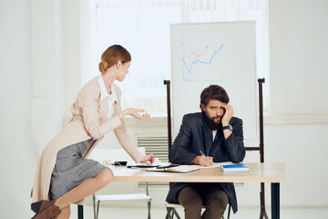 man and woman in the office at the desk, communication, work