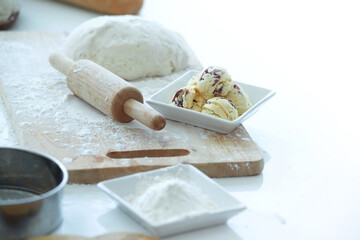 Rolling Pin, dough bread and baking ingredients placed on table, food preparation concept
