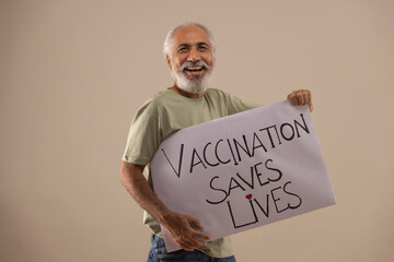 A HAPPY OLD MAN HOLDING VACCINATION AWARENESS POSTER