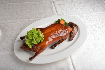 chinese bbq roasted braised whole peking duck meat with slices mango vegetables and herb sauce asian halal menu