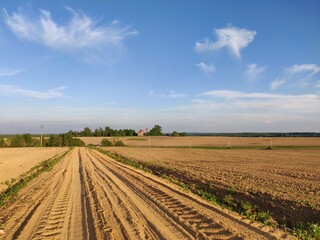 plowed field in the country and blue sky