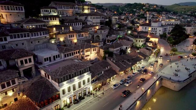 Night view of Berat, Albania. Flying over old houses, city with illumination. Berat is one of the most beautiful cities in Albania