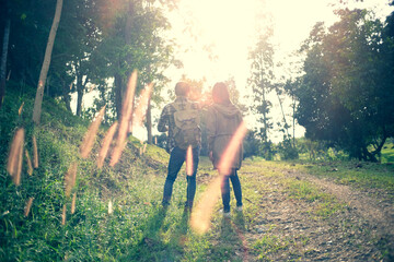 Couple of traveler hiking at mountain with route map and navigator.