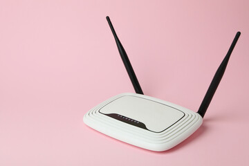 Wi-Fi router with external antennas on pink background