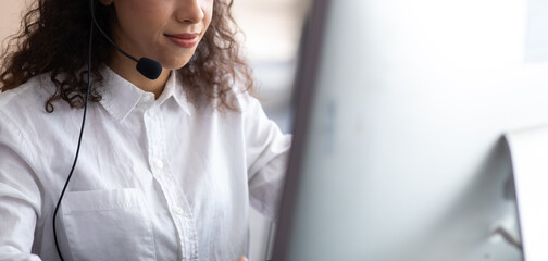 Hispanic woman call center service support in headset. Female customer support or sales agent.