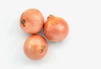 Top view small group of onion, three onions on white background with skin.