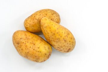 Top view small a group of fresh potato on white background, close up image three potatoes, soft shadow.