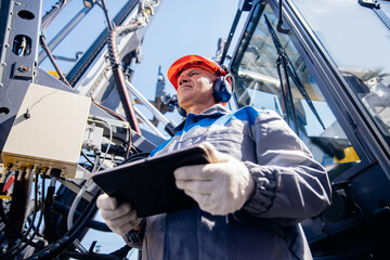 Industry operator use mobile tablet for control drilling rig for exploration of minerals for oil,...