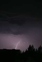 Naklejka na ściany i meble Lightning during a storm over the city in the nightLightning during a storm over the city in the night