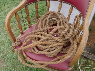 Coils of thick rope laid on an antique chair at a flea market