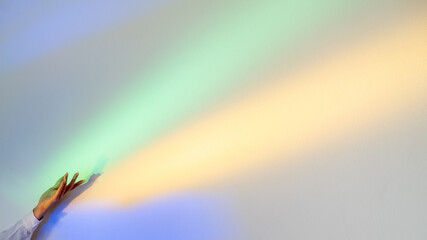 Ethereal energy. Advertising background. Holy light. Rainbow ray. Woman hand flowing blurred soft...