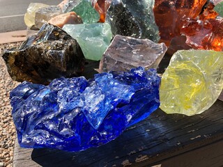 Large chunks of uncut gemstones in different colors
