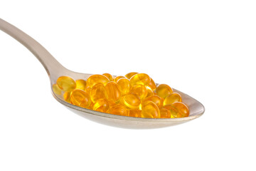 Spoon with vitamin K pills on white background, closeup