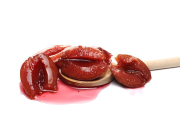 Plum compot with wooden spoon, fruit kompot isolated on white background