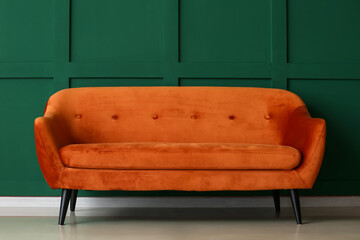 Stylish sofa near color wall