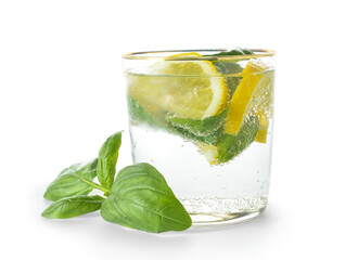 Glass of tasty lemonade with basil on white background