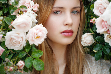 Beautiful young woman smells a rose flower. High quality photo