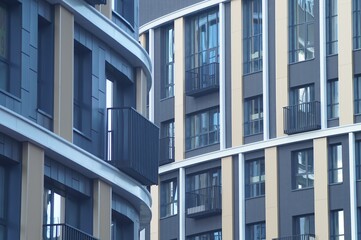 Photo of a part of the facade of a new building. Classical architecture in the understanding of the architect of the 21st century. In dark blue and purple tones with contrasting details. Windows, semi