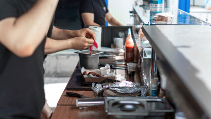 Multiple working cooks in a BBQ pub. Street Food