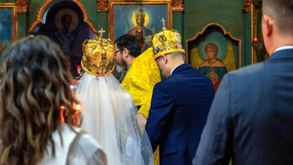 Obraz na płótnie Canvas People at wedding ceremony, orthodox priest serving in a church