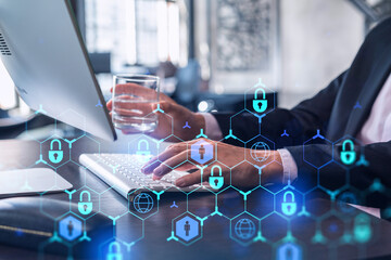 A programmer is typing a code on computer to protect a cyber security from hacker attacks and save...