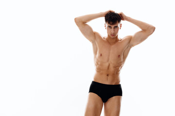 Fototapeta premium brunette man in panties and naked torso holds hands near face 