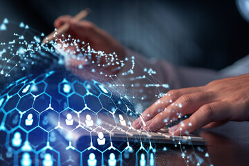 Hands of hr specialist is typing the keyboard in the internet to find the best candidates to create international network in recruitment process. Formal wear. Social media hologram icons.