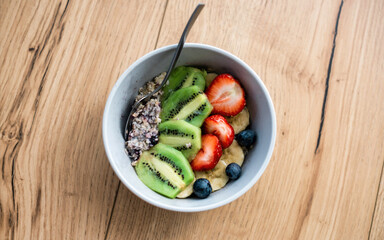 Healthy porridge made of fruits and berries, top view