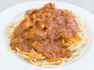 Spaghetti pork bolognese on a white plate