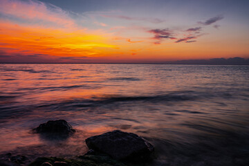 Obraz premium Sunset on the sea, beautiful nature view, colors of the sky and the sun, purple texture of the evening, landscape scene