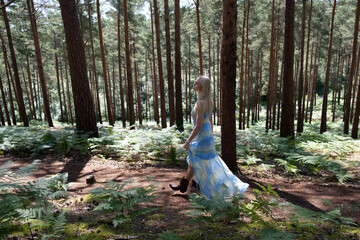 beautiful girl walking through a forest