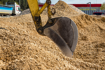 Industrial background. Digger bucket close-up. Construction excavator bucket.